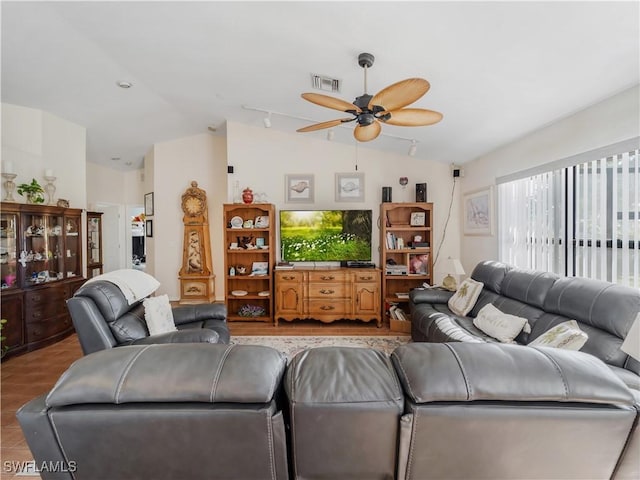 living room with ceiling fan and lofted ceiling