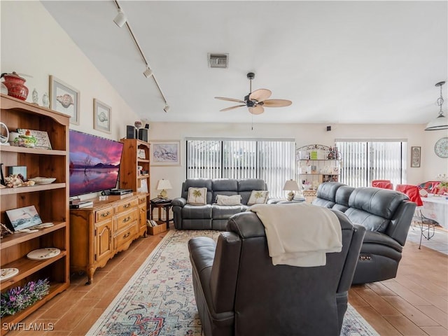 living room featuring ceiling fan and rail lighting