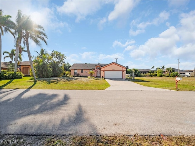 ranch-style home with a garage and a front lawn