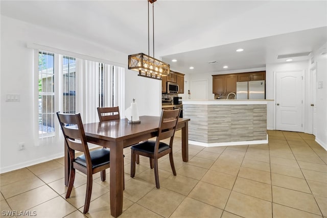 dining room featuring a chandelier and light tile patterned floors