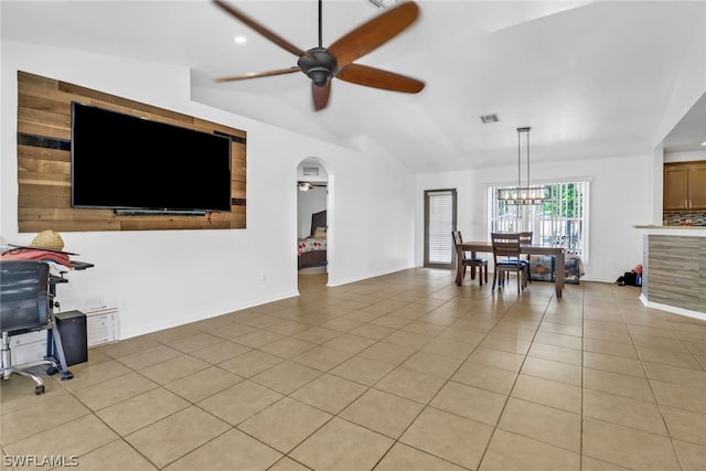 living room featuring ceiling fan with notable chandelier and light tile patterned floors