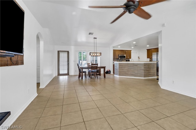 living room featuring ceiling fan with notable chandelier and light tile patterned floors