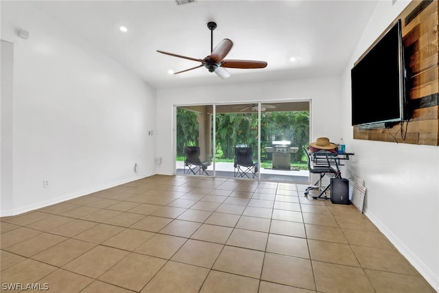 tiled spare room featuring ceiling fan