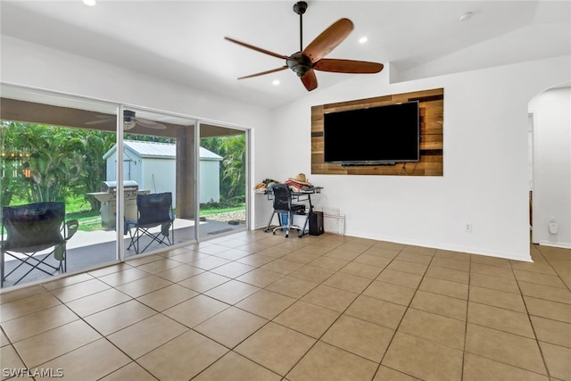 unfurnished living room with tile patterned flooring, vaulted ceiling, and ceiling fan