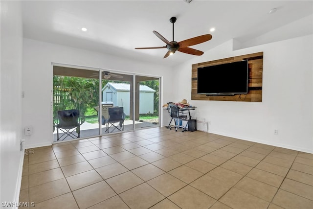 empty room featuring light tile patterned floors, ceiling fan, and vaulted ceiling