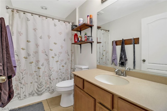 bathroom with vanity, toilet, and tile patterned flooring