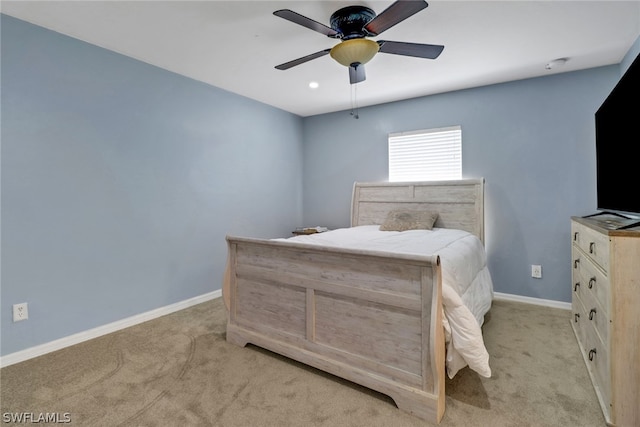 bedroom featuring light carpet and ceiling fan