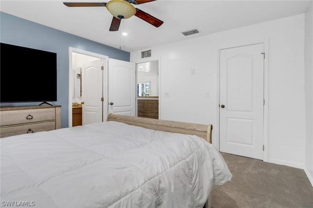 carpeted bedroom featuring ensuite bathroom and ceiling fan