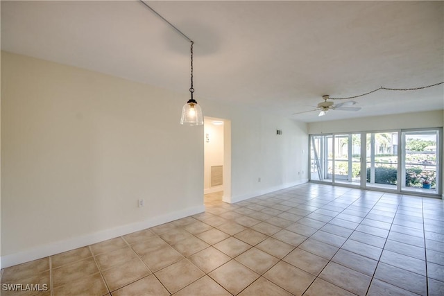 spare room featuring light tile patterned flooring and ceiling fan