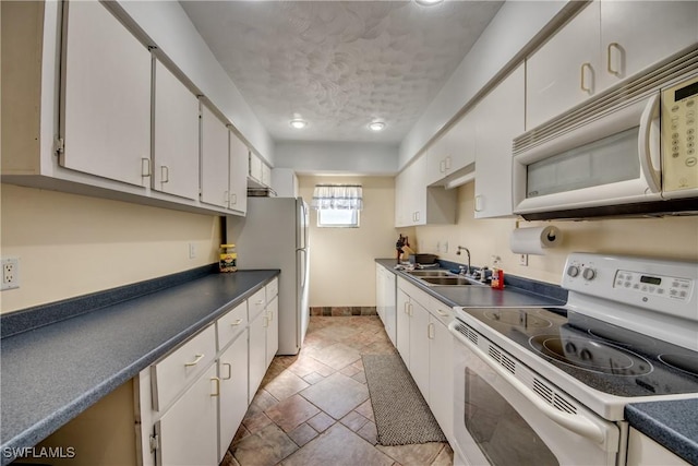 kitchen featuring white cabinetry, sink, white appliances, and a textured ceiling