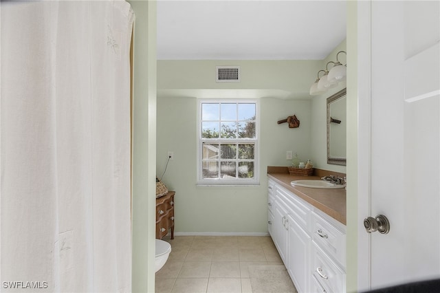 bathroom featuring tile patterned flooring, vanity, and toilet