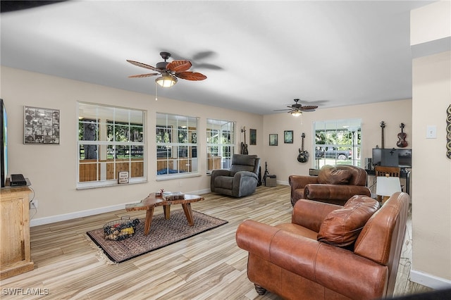 living room with ceiling fan and light hardwood / wood-style floors