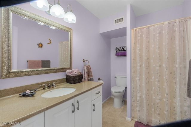 bathroom featuring tile patterned flooring, vanity, and toilet