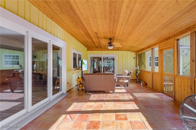 sunroom featuring ceiling fan and wood ceiling