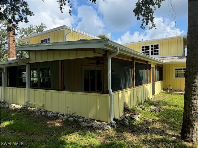 view of side of property featuring a sunroom