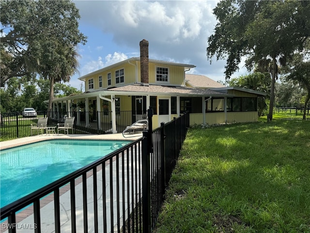 view of pool with a yard