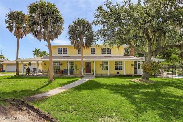 farmhouse inspired home with a porch and a front yard