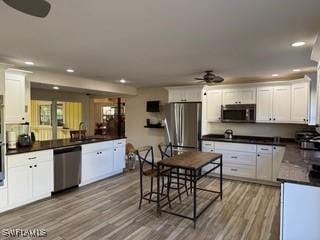 15700 Bahama Way, Bokeelia, FL 33922 - kitchen with stainless steel appliances, a ceiling fan, dark countertops, a sink, and recessed lighting