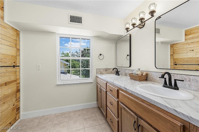15700 Bahama Way, Bokeelia, FL 33922 - bathroom with baseboards, double vanity, and tile patterned flooring