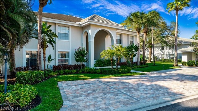 mediterranean / spanish-style house featuring a front yard