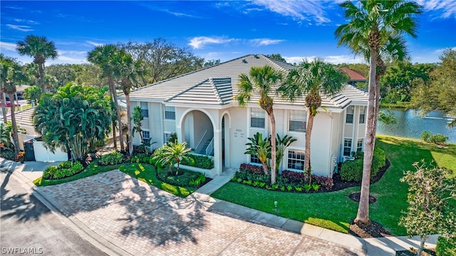 mediterranean / spanish house with a front lawn