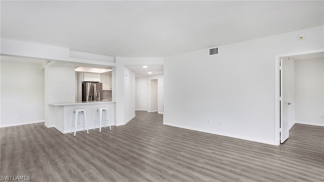 unfurnished living room with hardwood / wood-style floors