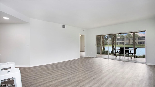 unfurnished room with hardwood / wood-style floors