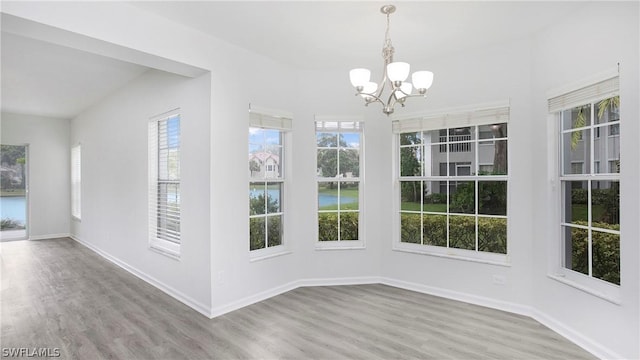 unfurnished sunroom featuring a chandelier