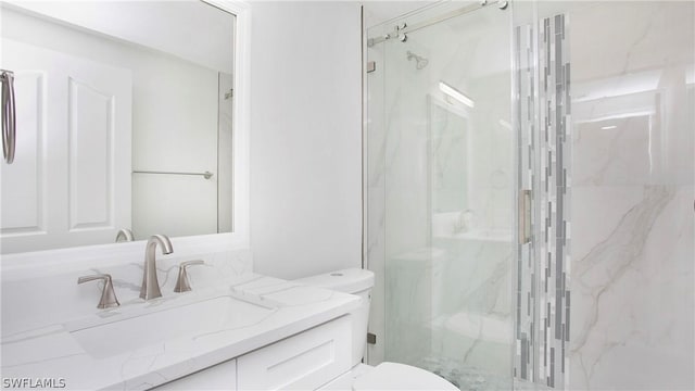 bathroom featuring vanity, toilet, and an enclosed shower