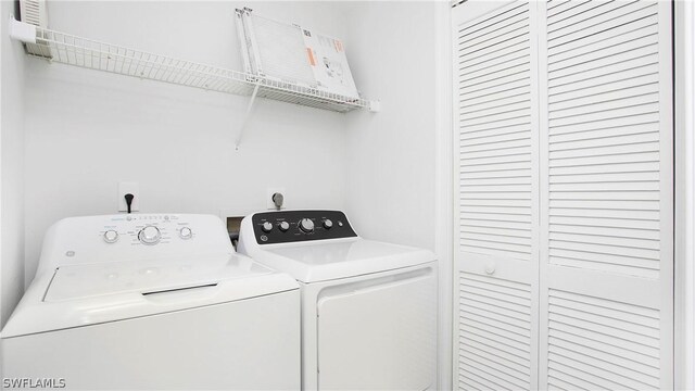 clothes washing area with washer and clothes dryer