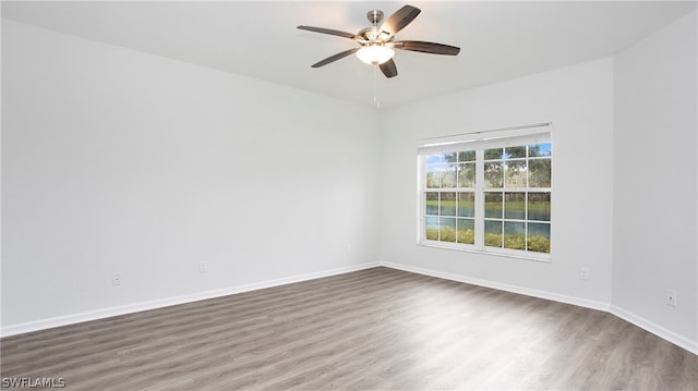 spare room featuring wood-type flooring and ceiling fan