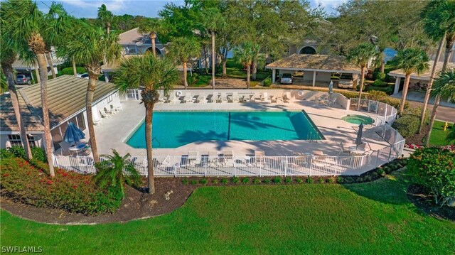 view of swimming pool featuring a yard and a patio area