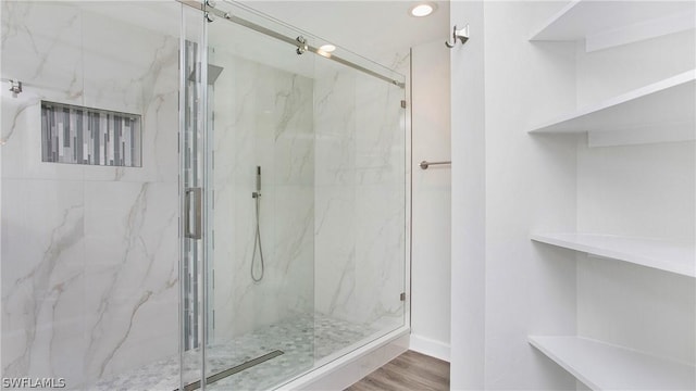 bathroom featuring hardwood / wood-style floors and walk in shower