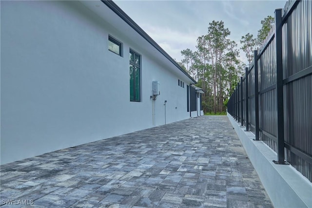 view of side of home featuring a patio area and stucco siding