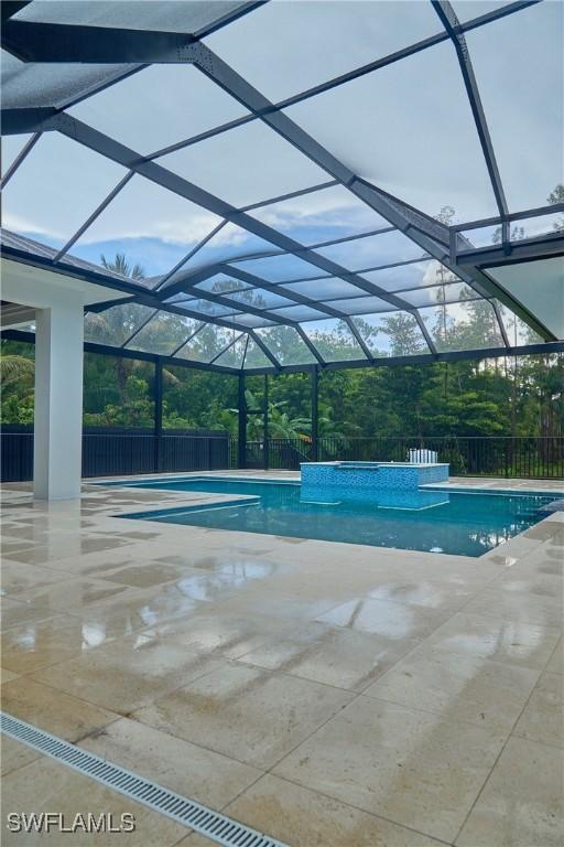 view of pool featuring a patio area, a lanai, a fenced in pool, and fence