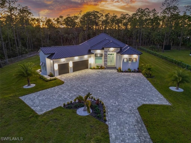 view of front of house with a yard and a garage