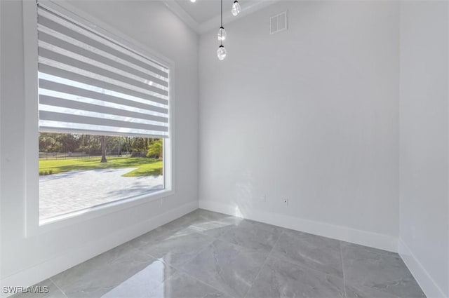 empty room featuring crown molding