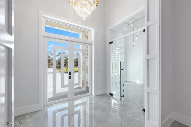 doorway featuring a chandelier and french doors