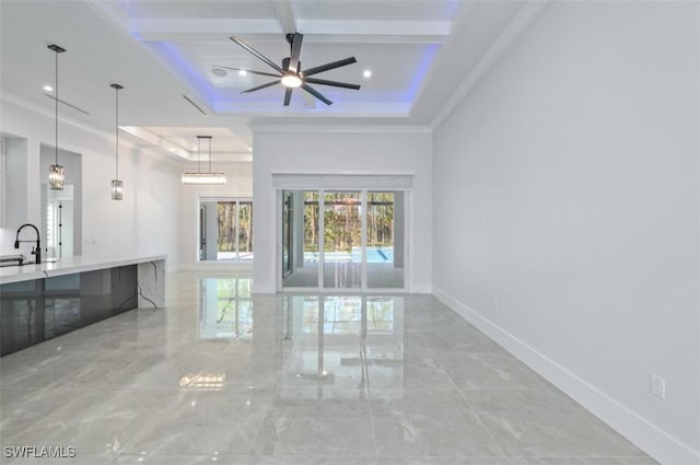 unfurnished living room with ceiling fan, beam ceiling, a raised ceiling, and sink