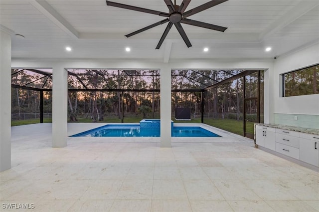 view of swimming pool featuring a lanai and a patio