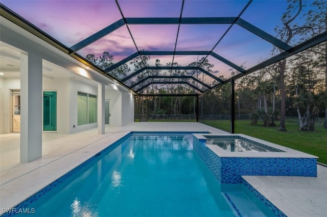 pool at dusk featuring an in ground hot tub, a patio, and glass enclosure