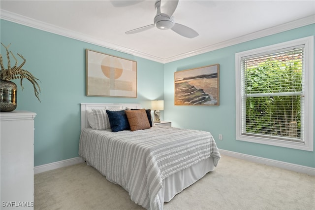 carpeted bedroom featuring ceiling fan and ornamental molding