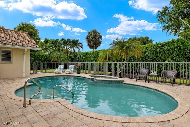 view of pool with an in ground hot tub and a patio