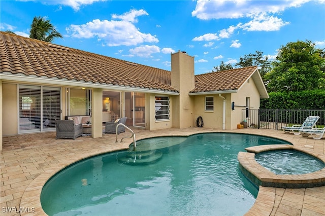 view of swimming pool featuring an in ground hot tub, an outdoor hangout area, and a patio area