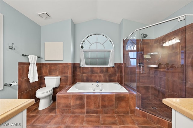 full bathroom featuring lofted ceiling, toilet, tile walls, vanity, and plus walk in shower