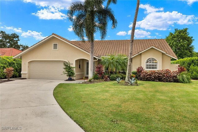 view of front of house featuring a garage and a front lawn