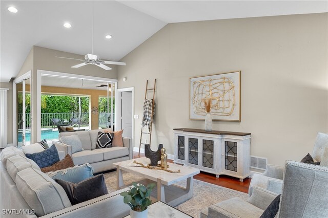 living room with hardwood / wood-style flooring, high vaulted ceiling, and ceiling fan