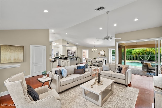 living room featuring lofted ceiling, ceiling fan with notable chandelier, and light wood-type flooring