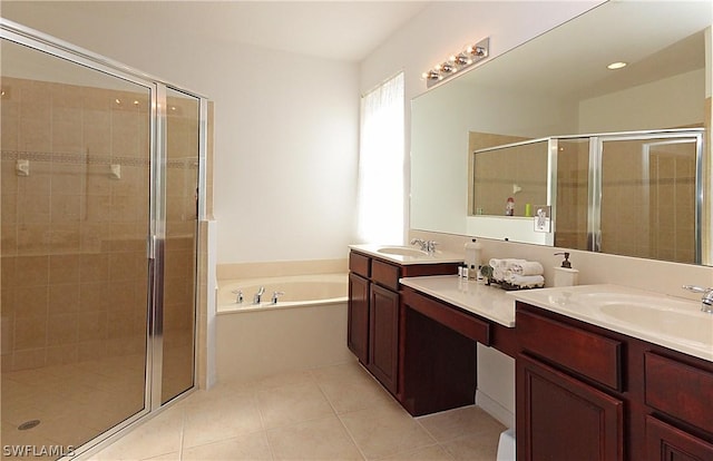 bathroom featuring tile patterned flooring, vanity, and separate shower and tub