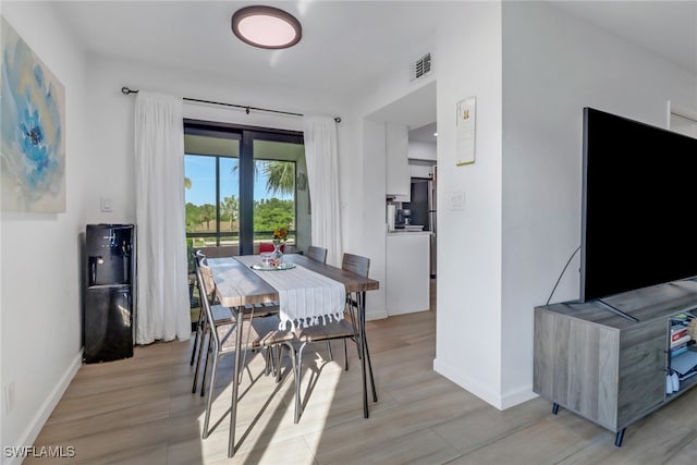 dining area with light hardwood / wood-style floors